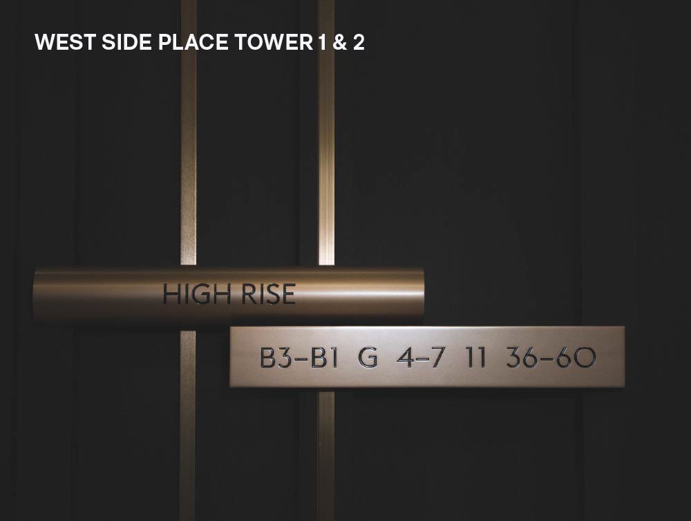 west side place's golden-finished wayfinding signs with black texts stacked together.