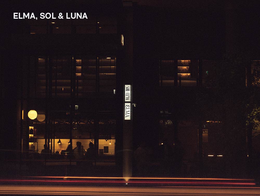 lightbox that says elma and sol&luna on the facade of a building